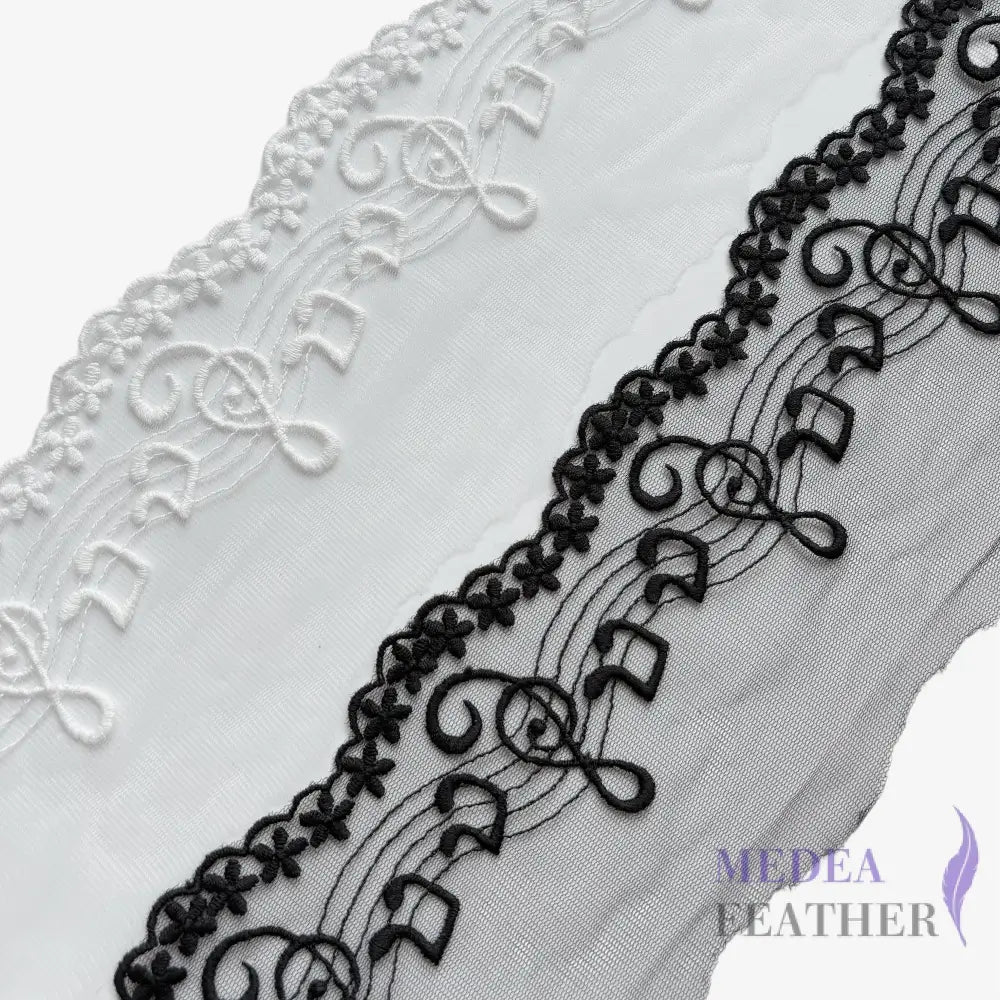 Black and off-white tulle lace trim with embroidered music note patterns.
