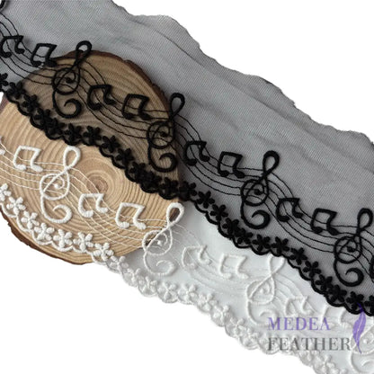 Black and off-white tulle lace trim with embroidered music note patterns.