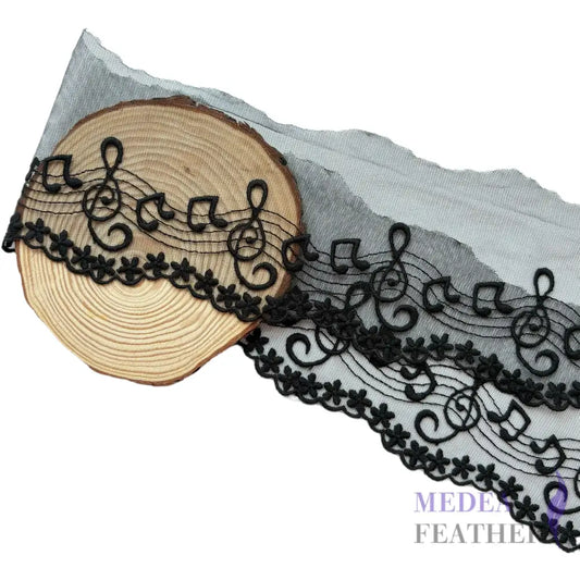 Black and off-white tulle lace trim with embroidered music note patterns. - Black